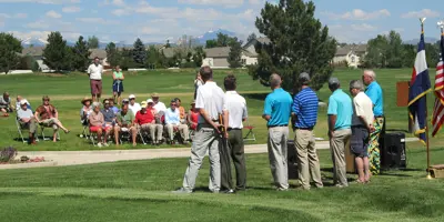 A crowd of people watching a golf game.